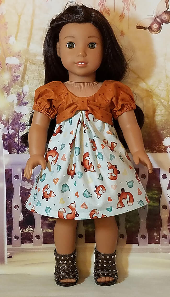Our FREE GIFT to Lee & Pearl mailing list subscribers — Pattern 1038: The Gift Bow Front Dress for 18 Inch American Girl, 16 Inch A Girl for All Time and 14 1/2 Inch Wellie Wisher and similar dolls. Click to sign up! Here's American Girl Nanea in an adorable fox print dress, balanced with a coordinating earthy brown calico on top. Nice work, Jozel W!