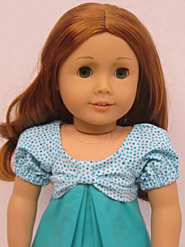 Our FREE GIFT to Lee & Pearl mailing list subscribers — Pattern 1038: The Gift Bow Front Dress for 18 Inch American Girl, 16 Inch A Girl for All Time and 14 1/2 Inch Wellie Wisher and similar dolls. Click to sign up! Here's a red-headed American Girl doll looking stylish in a pair of coordinating teal blue fabrics. Mary H. made this dress, and we think it looks fantastic.
