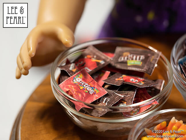 Happy Halloween from Lee & Pearl! We’ve got a YUMMY tutorial for you and your dolls today. Follow along as we show you how to make wonderfully realistic 18 inch doll-size replicas of popular fun-size bagged candies. Skittles and M&Ms are our favorites. What are yours?
