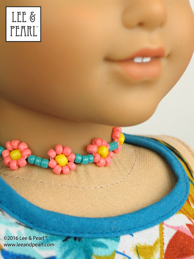 Make your doll’s dress — and the jewelry to go with it! Our popular Pattern 1032: Desert Sunrise Maxi Dress, Halter Top and Beaded Chokers for 18 Inch Dolls includes an easy introduction to beadwork, with a selection of doll-scale necklace projects like this daisy chain choker on our American Girl Doll. Find this pattern in the Lee & Pearl Etsy shop at https://www.etsy.com/listing/397805083/lp-1032-desert-sunrise-maxi-dress-halter