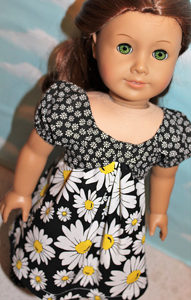 Our FREE GIFT to Lee & Pearl mailing list subscribers — Pattern 1038: The Gift Bow Front Dress for 18 Inch American Girl, 16 Inch A Girl for All Time and 14 1/2 Inch Wellie Wisher and similar dolls. Click to sign up! Karen L. made this vibrant cotton version out of small- and large-scale daisy prints. Large prints don't always work on dolls, but with the simple cut of the skirt and the smaller print balancing everything out, this combo is a real winner.
