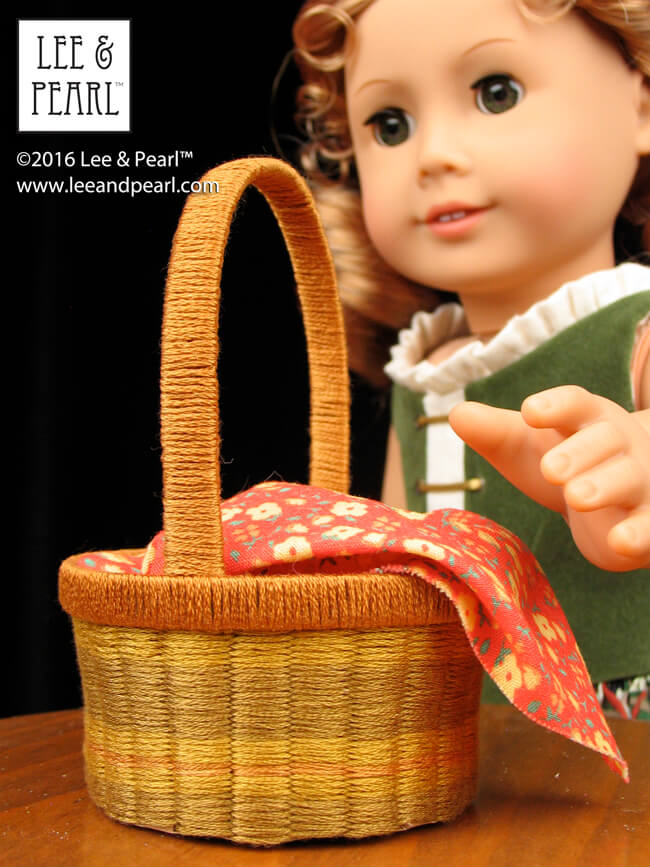 Happy Easter from Lee & Pearl! Make beautiful baskets for your 18 inch / American Girl dolls using inexpensive ribbon or embroidery floss, card stock and Lee & Pearl’s FREE tutorial and printable package.