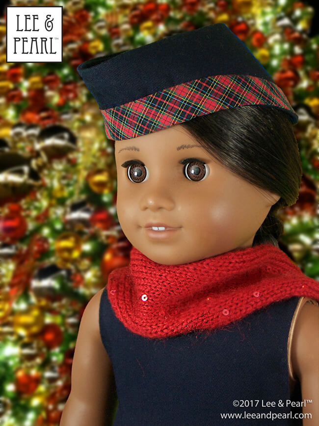 Our American Girl® Sonali doll is wearing a holiday cap made using Lee & Pearl Pattern 2021: The Glengarry Hat for 18 Inch Dolls.