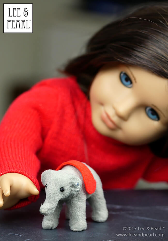 It’s the most wonderful time of the year — when 18 inch doll-scale accessories and props show up in all the stores, masquerading as CHRISTMAS ORNAMENTS. Lee & Pearl found this tiny toy elephant at Jo-Ann Fabric and Craft, and turned it into a doll-scale replica of a vintage Steiff toy for our American Girl doll. What have you found this year?